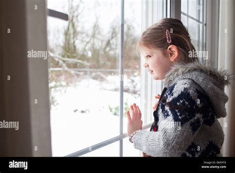 Young Girl Looking Out Of Window View At The Top Hi Res Stock