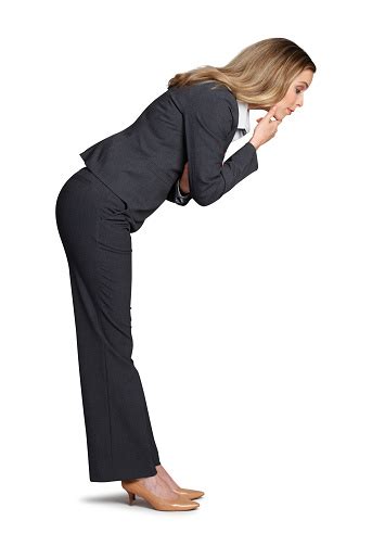 Businesswoman Bending Over And Looking Into The Unknown Stock Photo