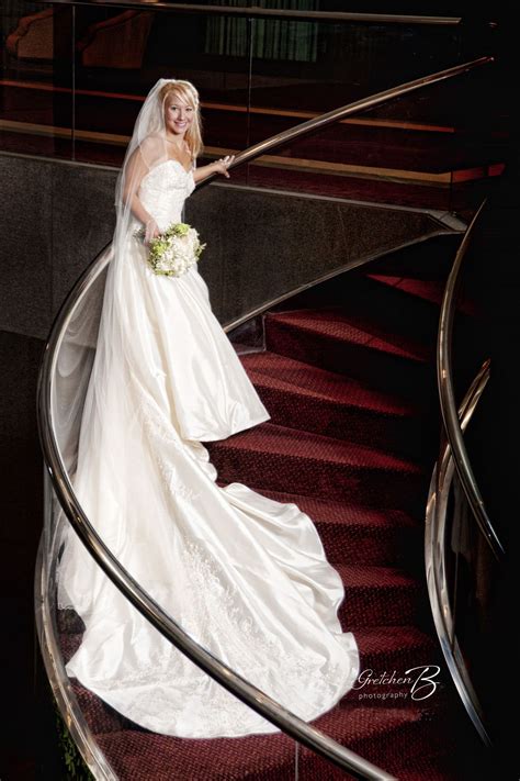 Great Side Shot Of A Bride Posing On The Spiral Staircase At The