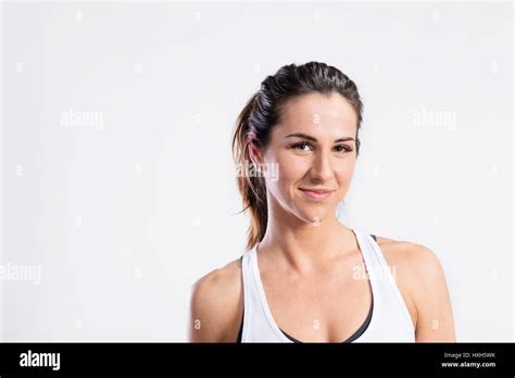 Attractive Young Fitness Woman In White Tank Top Studio Shot Stock
