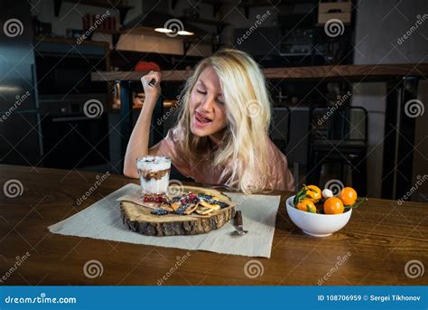 Young Woman Eats Fresh Pancakes With Dessert On The Breakfast In The