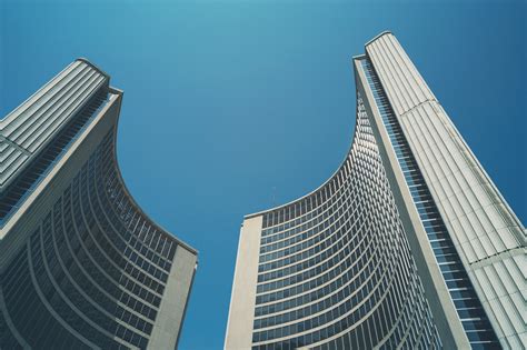 Two Curved Towers Of Toronto City Hall Under A Blue Sky Toronto City