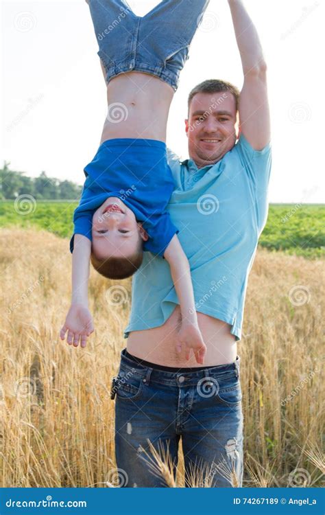 Dad Holding Kid Upside Down