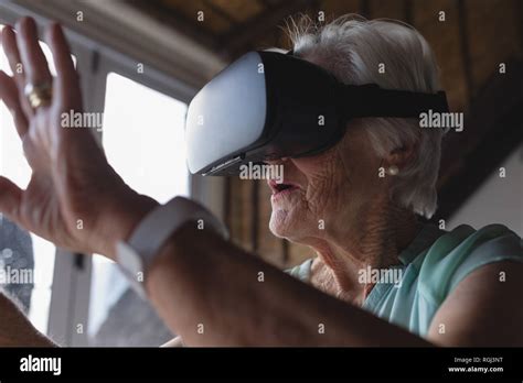 Senior Woman Using Virtual Reality Headset Stock Photo Alamy