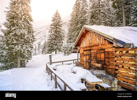 Wooden House In Winter Mountain Landscape Cottage Hut In Snowy