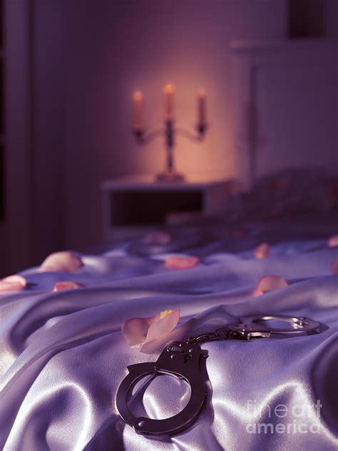 Handcuffs And Rose Petals On Bed Photograph By Oleksiy Maksymenko