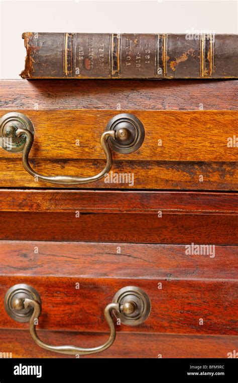 Antique Cabinet And Leather Bound Book Stock Photo Alamy