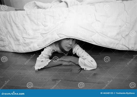 Portrait Of Little Girl Hiding Under Bed At House Stock Image Image