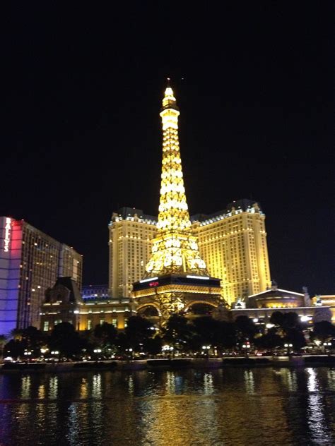 The Eiffel Tower Is Lit Up At Night In Las Vegas Nv