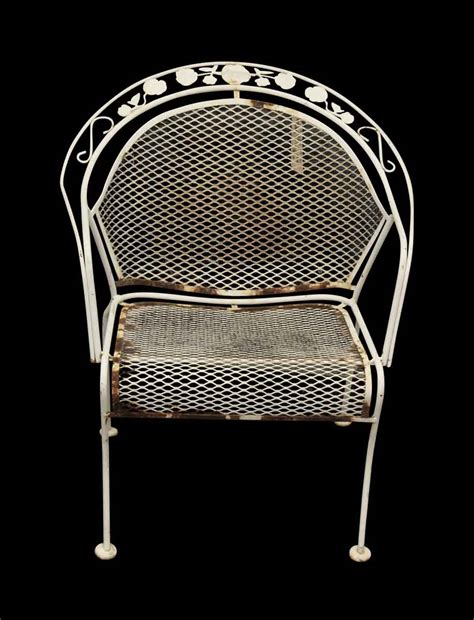 The perforated detailing of the back. Pair of White Metal Garden Chairs | Olde Good Things