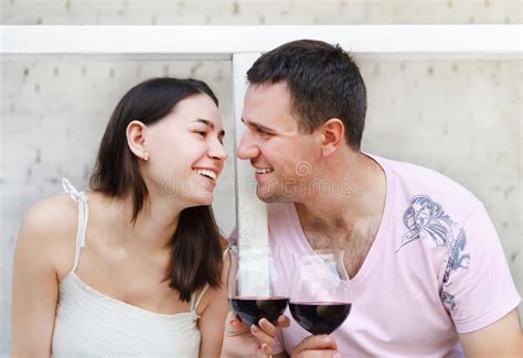 Young Happy Couple Enjoying A Glasses Of Red Wine Stock Image Image