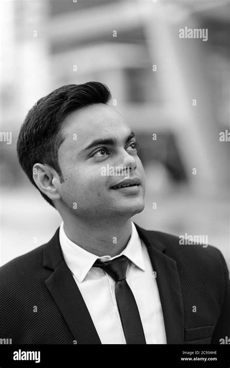 Young Handsome Indian Businessman In The City In Black And White Stock