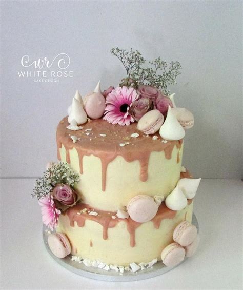 blush pink and nude two tier drippy cake with fresh cakesdecor
