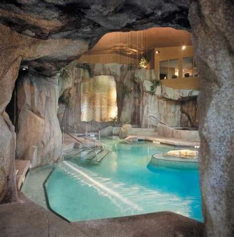 An Indoor Swimming Pool Surrounded By Large Rocks