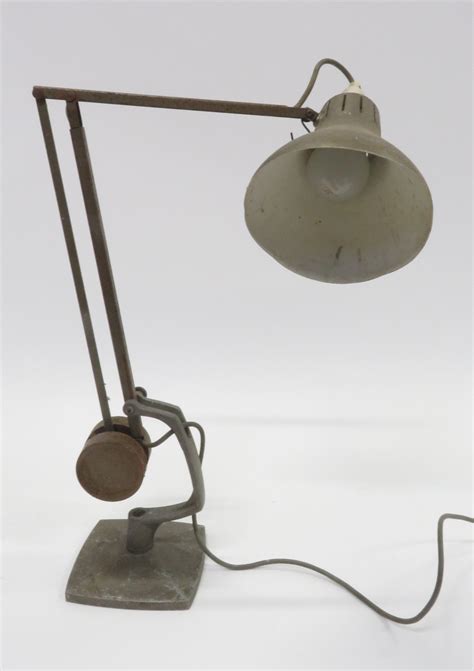 This classic line of lamps was designed by george carwardine and was first manufactured in bath england in the early 1930s. An Anglepoise style desk lamp, on square base