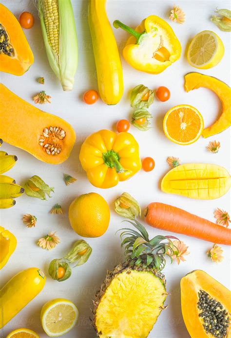 Yellow food on white background by Alita Ong - Stocksy United
