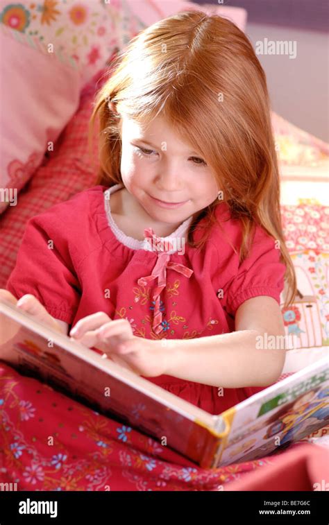 Little Girl Reading A Picture Book Stock Photo Alamy