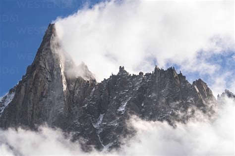 Aiguille Du Dru Mountain Surrounded With Clouds On Sunny Day Chamonix