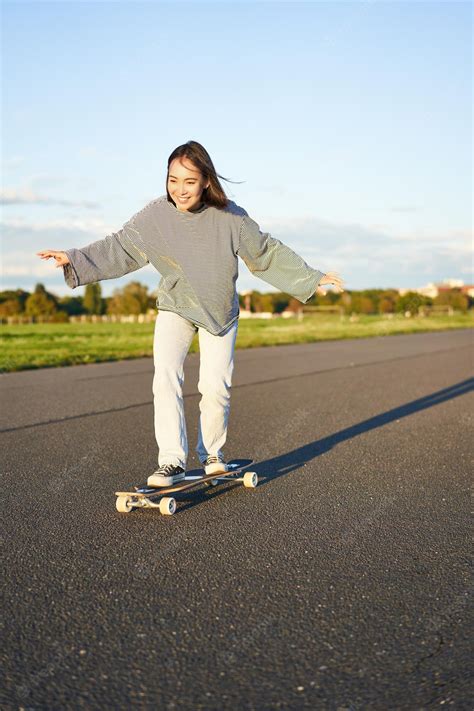 Free Photo Cute Asian Girl Riding Skateboard Skating On Road And Smiling Skater On Cruiser