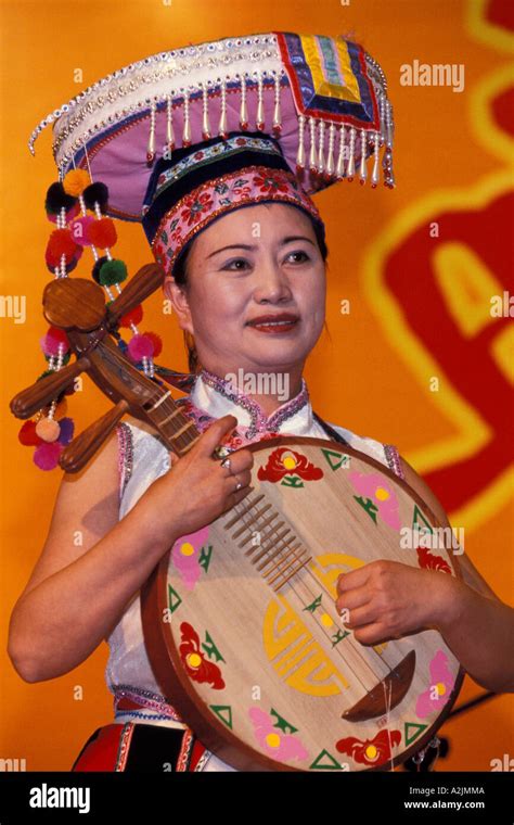 china yunnan province kunming woman plays the chinese lute at the international festival