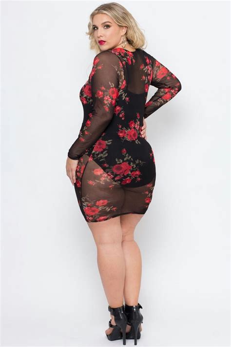 A Plus Size Woman Wearing A Black And Red Floral Print Dress With Sheer Mesh Sleeves