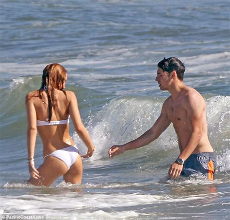 Bella Thorne Dons A White Bikini As She Dips In The Ocean With Gregg