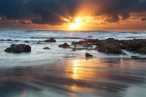 Sunrise Landscape Of Ocean With Waves Clouds And Rocks Stock Image