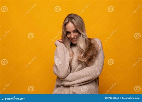 photo of shy blonde girl on yellow background stock image image of person girl 272250663