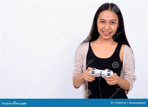 Portrait Of Happy Young Beautiful Asian Woman Playing Games Stock Photo