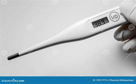 Hands Holding White Digital Thermometer On White Background Showed 38