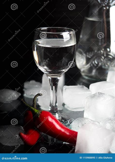 A Shot Of Vodka An Alcoholic Beverage Next To Ice Fire Ice Red