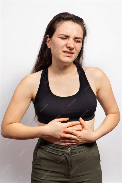Premium Photo A Woman Holds Hands On A Sick Stomach With A Ulcer Or Gastritis