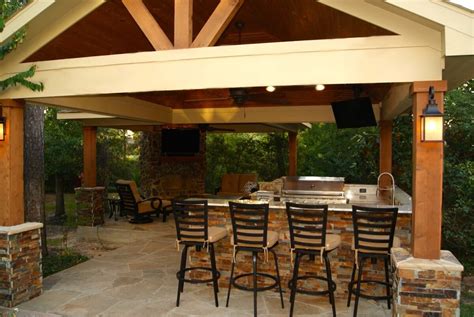 This incredibly spacious covered patio features a small outdoor kitchen, a large formal dining table and a cozy wicker seating area in front of a massive plaster and stone fireplace. Freestanding Patio Cover With Kitchen & Fireplace In The ...
