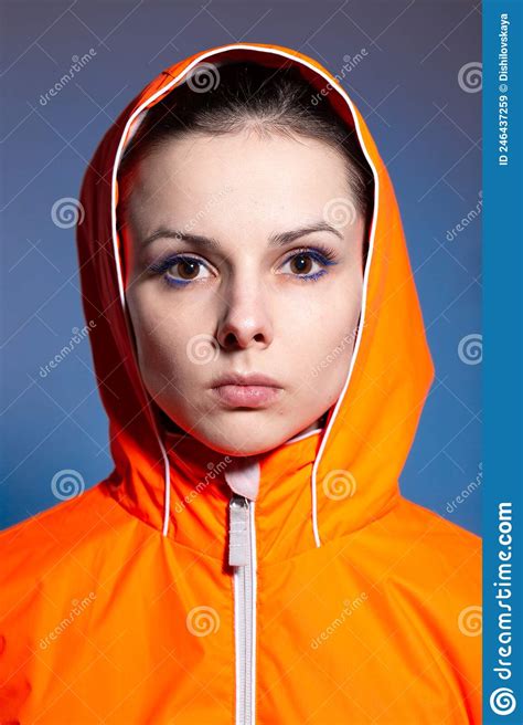 Brunette Woman In Orange Jacket Blue Background Stock Image Image Of