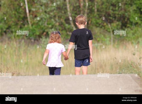 Brother And Sister Holding Hands During A Walk Around St Aidans Nature Park In Swillington West