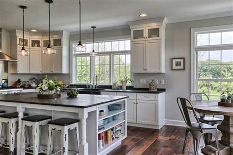 White shaker cabinetry is the ideal choice for farmhouse kitchens because of its effortless design and bright color. farmhouse kitchen remodel with black countertop white ...