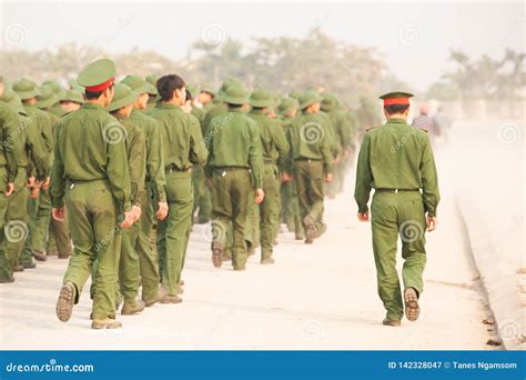 Rear View A Group Of Young Vietnamese Soldier Walking On The Street