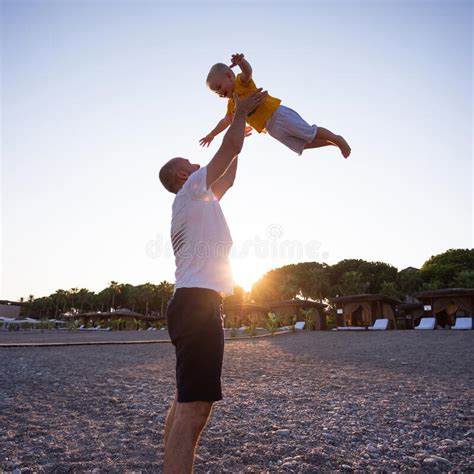 father and son having fun on the beach at sunset stock image image of happiness summer 169361255