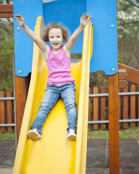 Young Girl On Slide In Playground Stock Image Image Of Years Looking