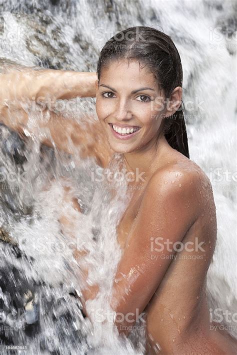Beautiful Woman Relaxing In A Natural Waterfall Spa Stock