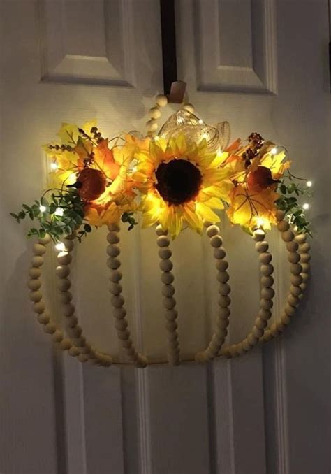 Sunflowers And Beads Are Hanging From The Front Door With Lights On