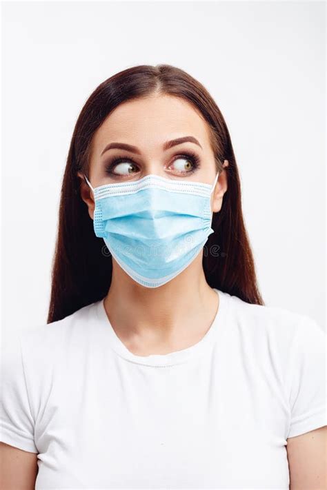 Brunette Woman Wearing Disposable Mask Looks Left With Wide Open Eyes