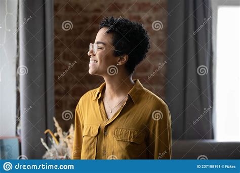 Happy Dreamy Millennial African American Woman Looking In Distance