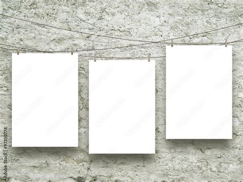 Three Empty Paper Sheet Frames Hanged By Clothes Pins On Scratched