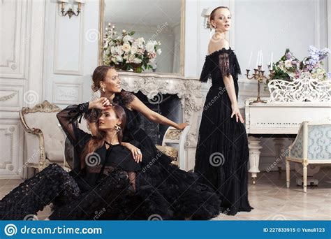 Three Young Pretty Lady In Black Lace Fashion Style Dress Posing In Rich Interior Of Royal Hotel