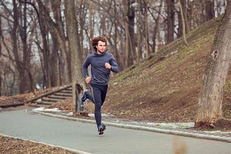 A Young Male Runner Runs In The Park Stock Photo Image Of Exercise