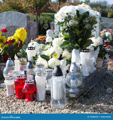People Remembering Their Loved Ones Who Died; On The Cemetery Royalty