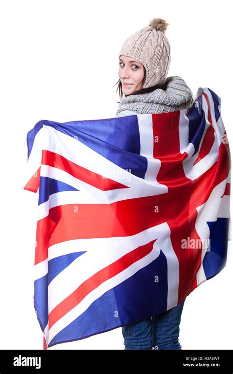 portrait of a beautiful british girl smiling holding up the uk flag isolated on white stock