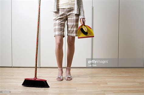 Detail Of Young Woman Holding Broom And Dustpan High Res Stock Photo