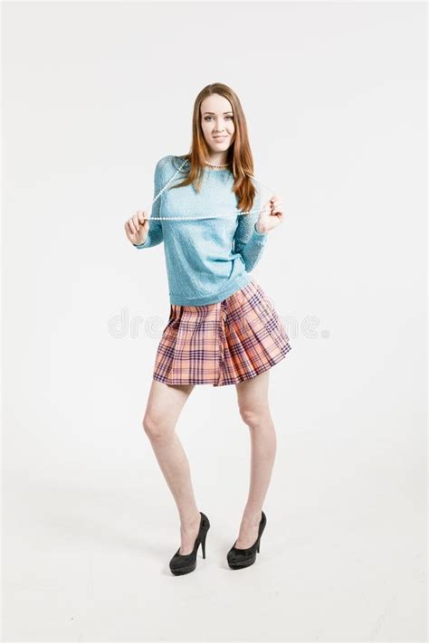 Image Of A Young Woman Wearing A Short Skirt And A Turquoise Pullover Stock Image Image Of